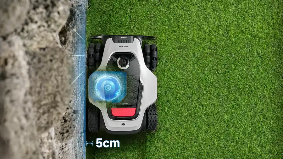 Dreame remote controlled lawn mower trimming precisely along a fence line