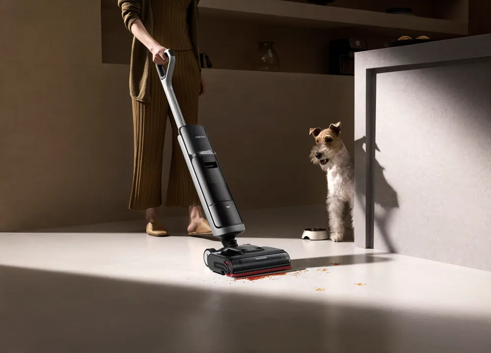 Dreame H15 Pro Heat washing a sealed kitchen floor with hot water, pet nearby.