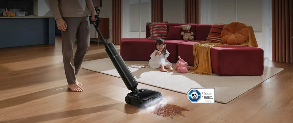 Cordless steam wet dry vacuum lifting a sticky spill from a wood floor with steam.
