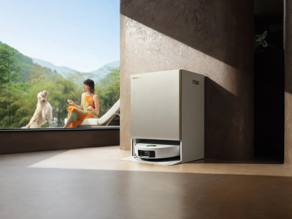 Dreame smart vacuum resting in its self-emptying dock in a living room