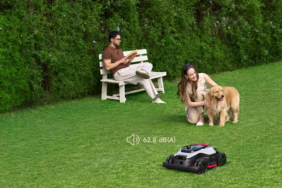 Dreame robot grass cutter mowing quietly on a suburban lawn at 62.8 dB.