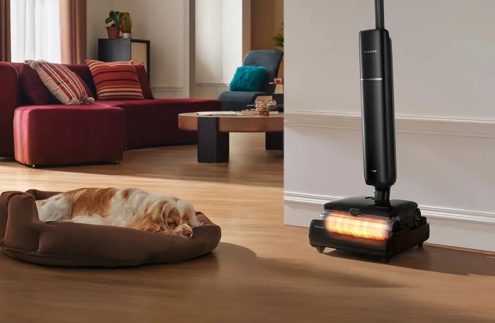 Wet dry vacuum drying its roller with heat in a living room while a dog rests nearby.