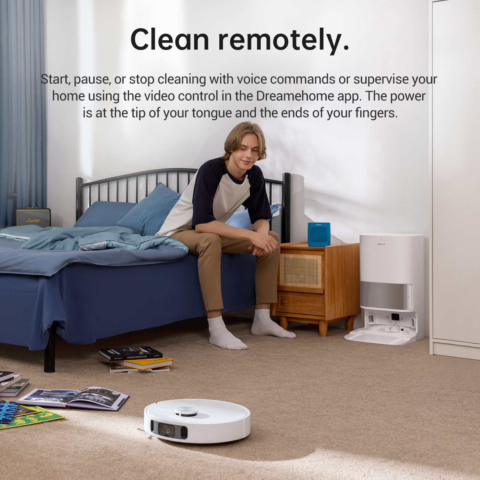 User controlling Dreame L10s Ultra Robot Vacuum remotely with video app on smartphone.