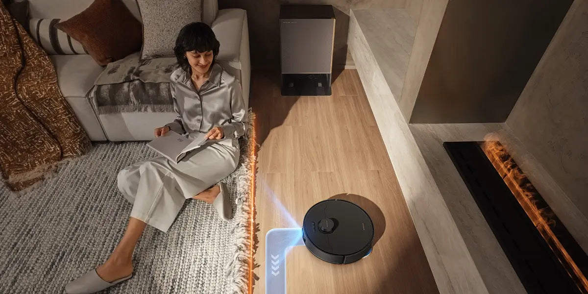Dreame Matrix10 Ultra cleaning a hardwood living room floor with a family and dog nearby